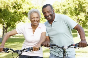 happy couple who is Aging In Place together on a bike ride